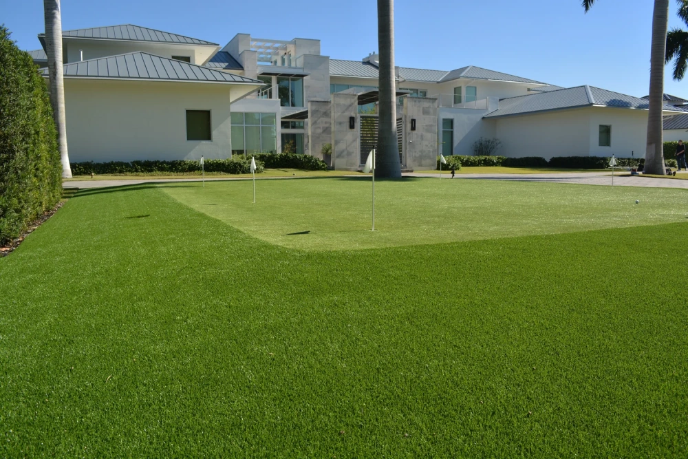 Outdoor putting green with artificial turf installed in front of a Rickie Fowler's home
